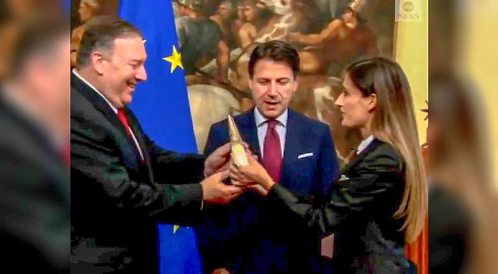 Pompeo mistakenly smiles and accepts protest cheese from anti-Trump Italian lawmaker