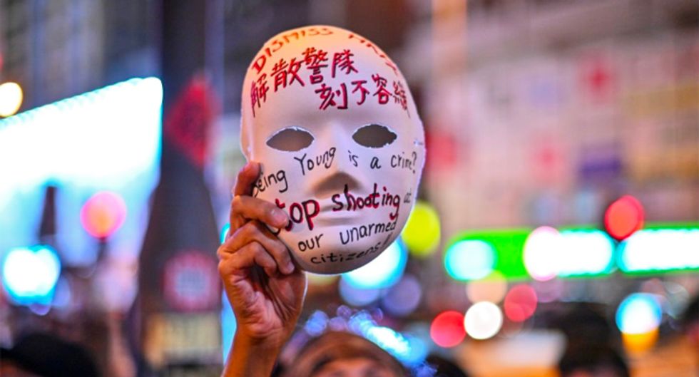 Police fire tear gas as large crowds defy Hong Kong mask ban