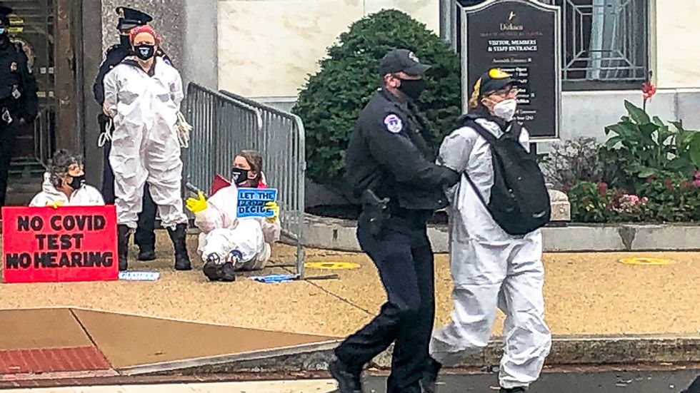 Amy Coney Barrett supporters shout 'law and order' as protesters are arrested outside confirmation hearing