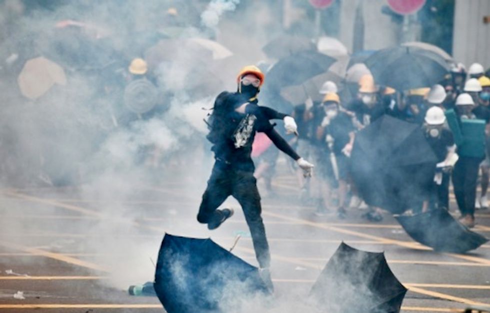 Hong Kong teen shot by police is charged with rioting, attacking officers