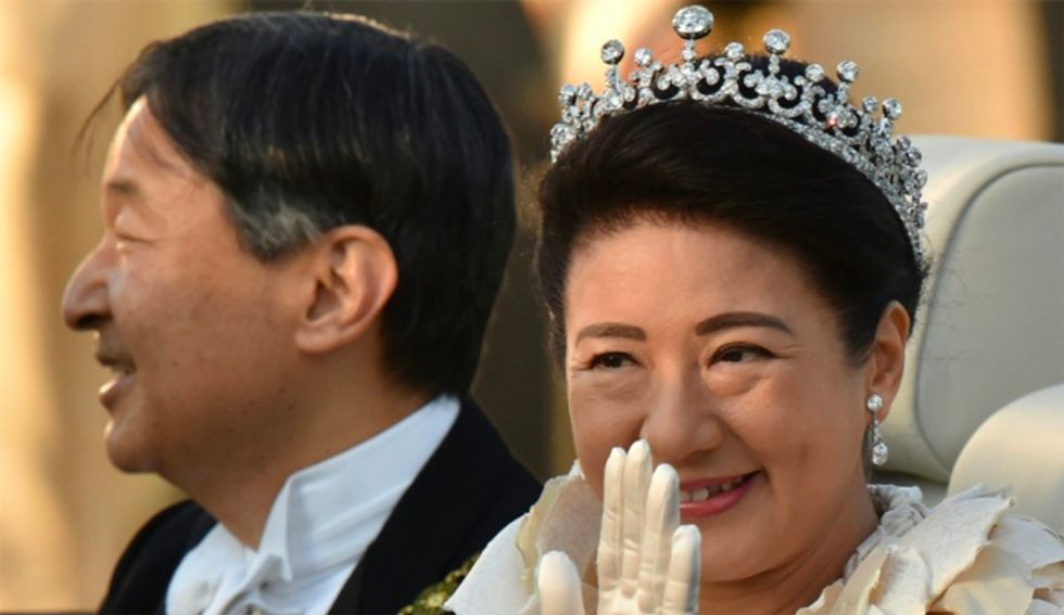 Cheering crowds greet Japan's new emperor in rare parade