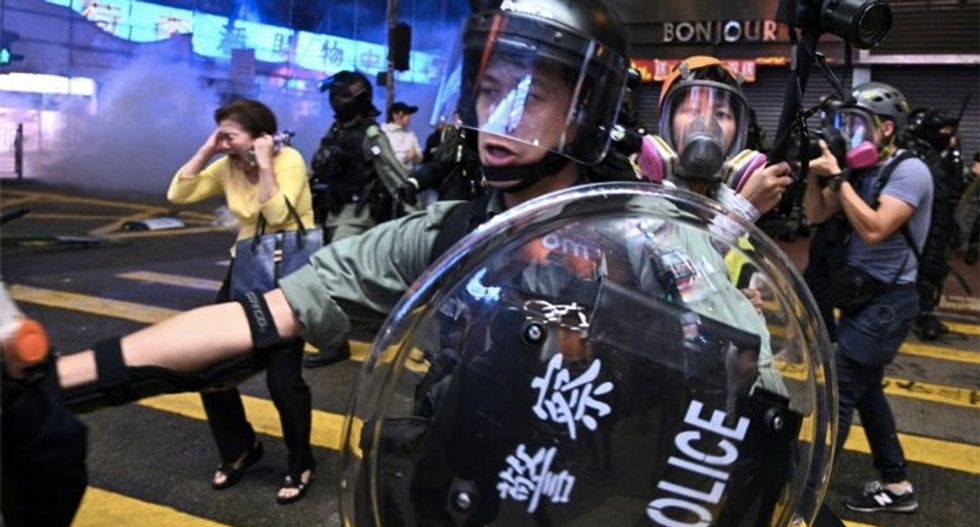 Hong Kong police shoot protesters with live rounds as protests continue
