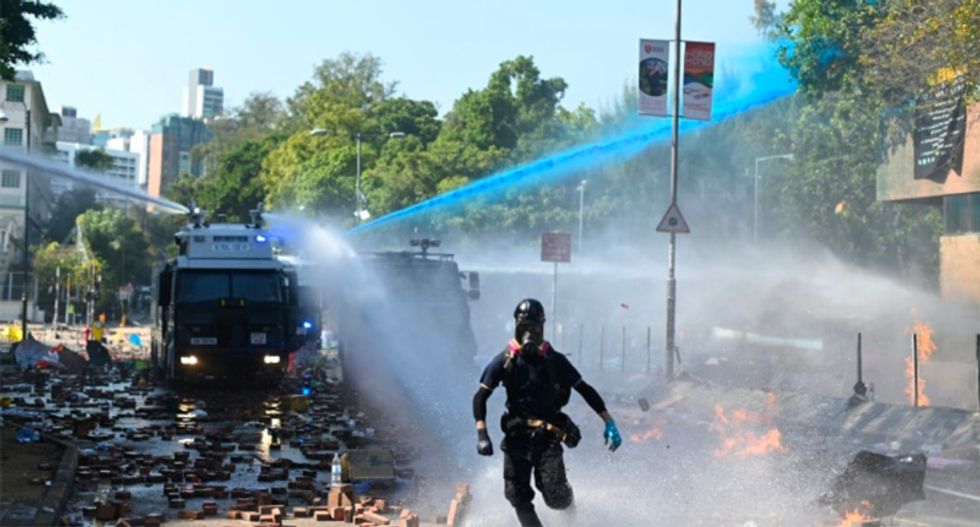 News Hong Kong police officer hit by arrow as protesters dig in at campus