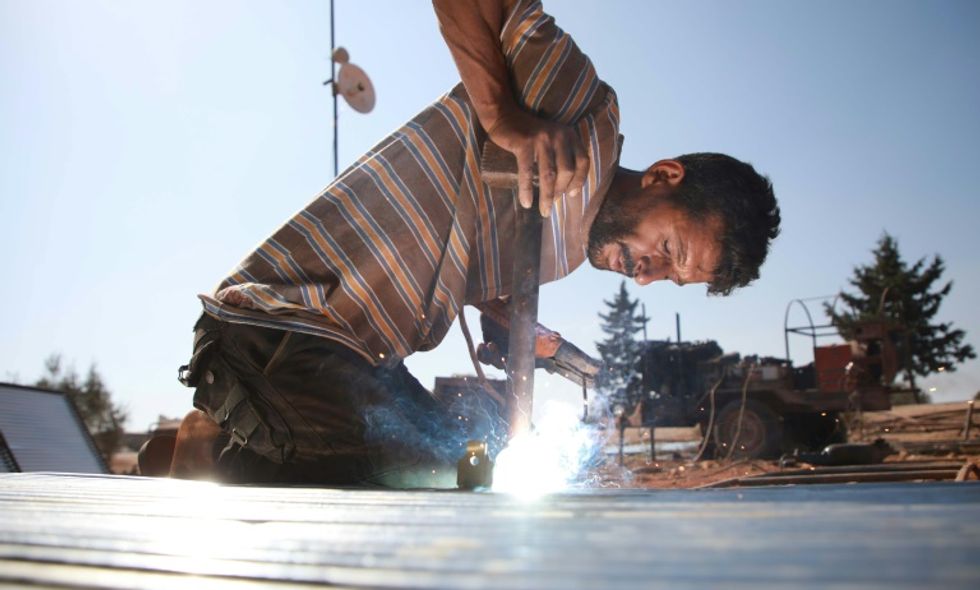Meet the man welding metal tubes for shelter for Syria's refugees