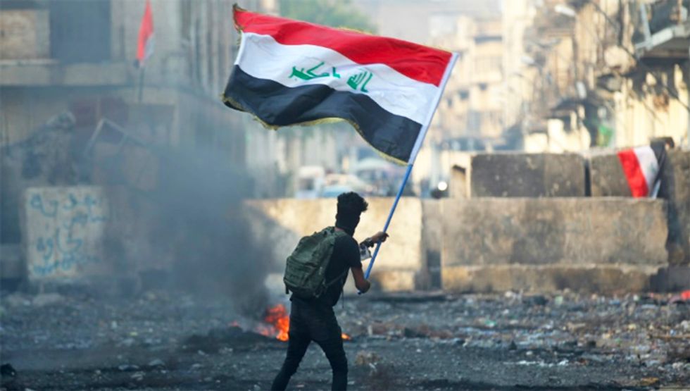 Iraq parliament approves PM resignation, protesters mourn dead