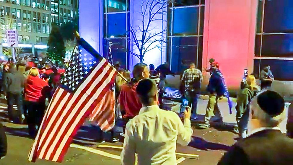 WATCH: Pro-Trump marchers violently rip down Black Lives Matter signs owned by local business