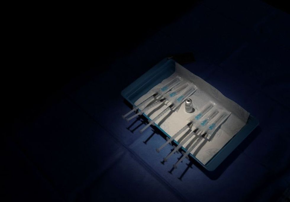 U.S. goal to squeeze more COVID shots from Pfizer vials hampered by syringe production