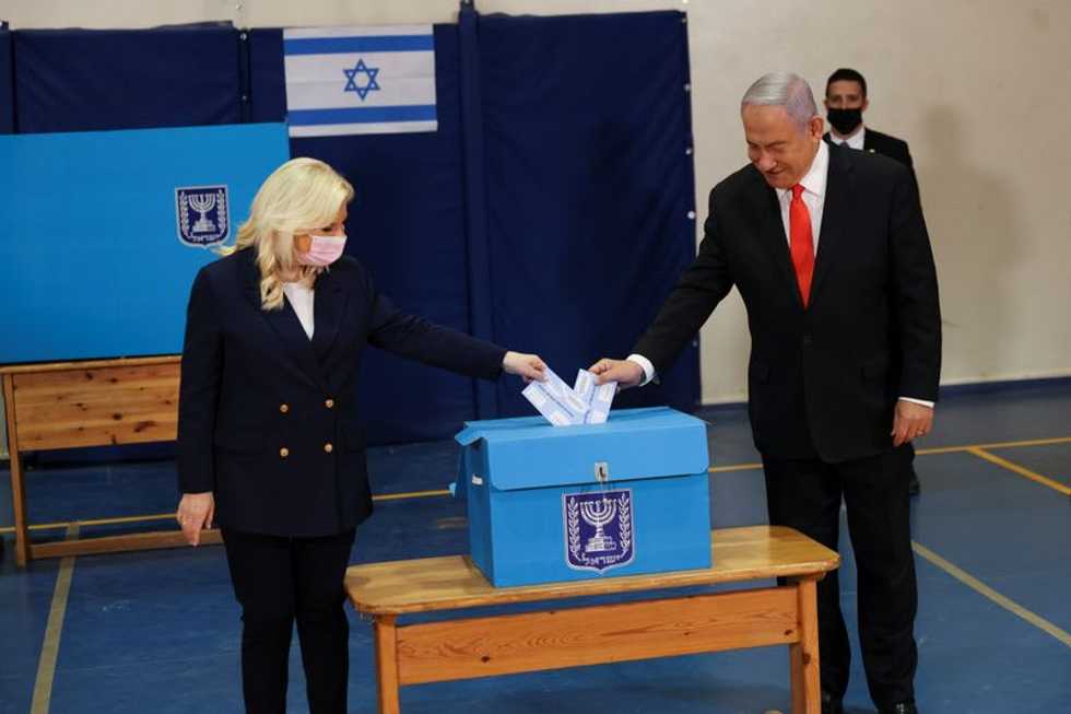 Israel votes as Netanyahu hopes vaccine rollout eclipses graft charges
