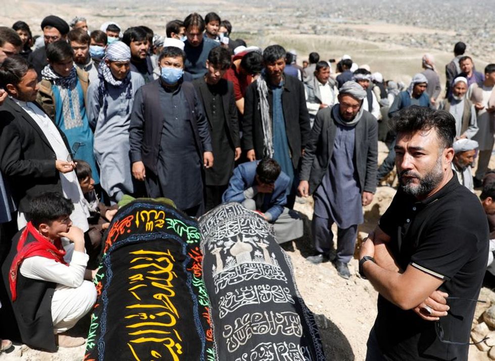 At least 68 killed in Afghan school blast, families bury victims