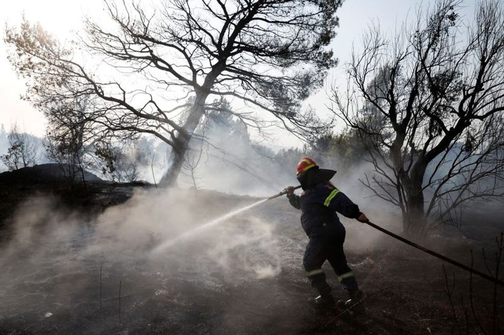 Tourists, residents evacuated by boat in Greece as wildfires rage