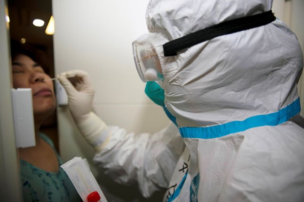 Shanghai places hundreds in quarantine after airport COVID-19 cases