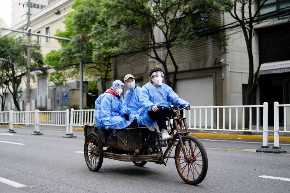 More Chinese cities impose COVID curbs as Shanghai cases rise