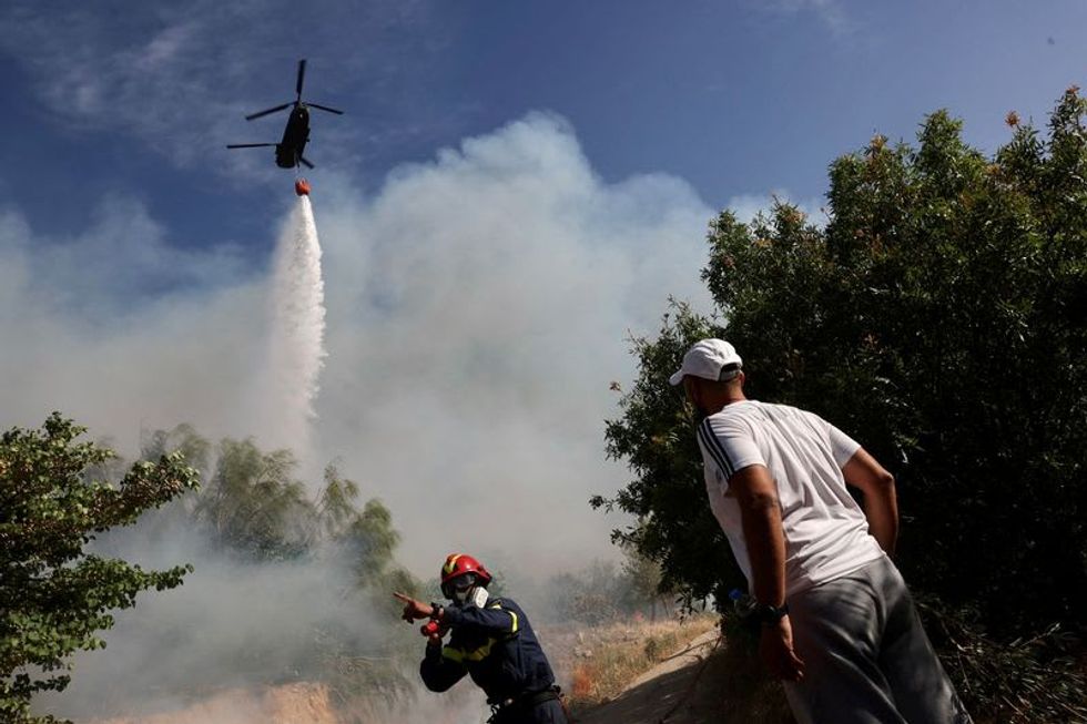 Wildfire rages near Athens, threatens homes