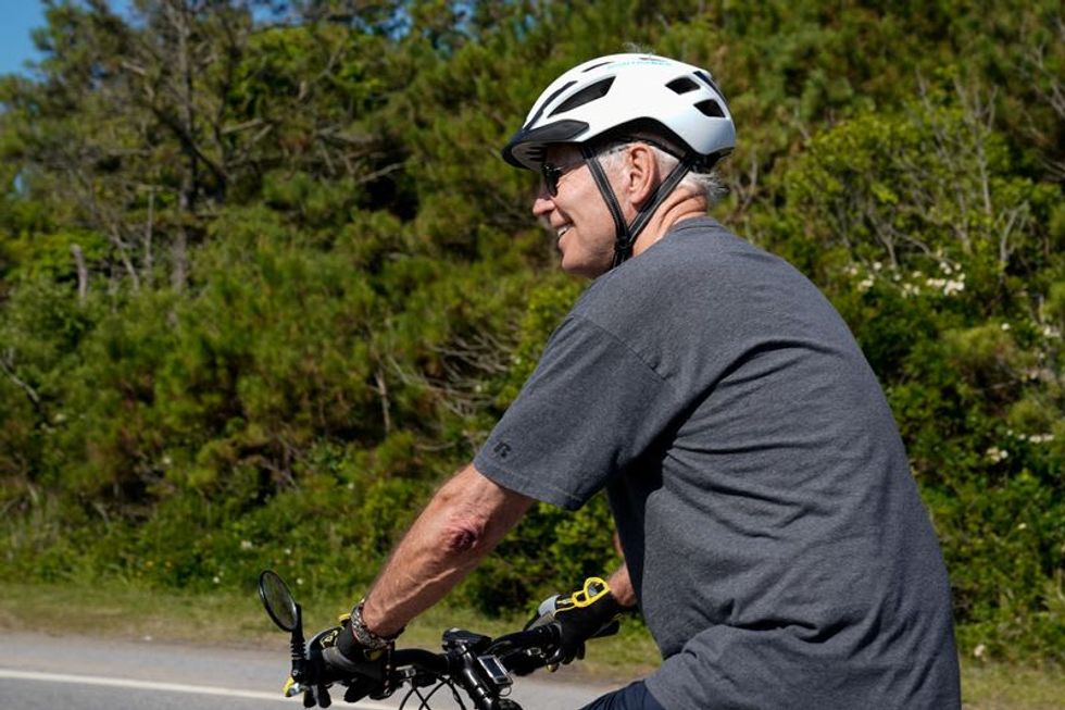 Biden falls after flubbing bike dismount