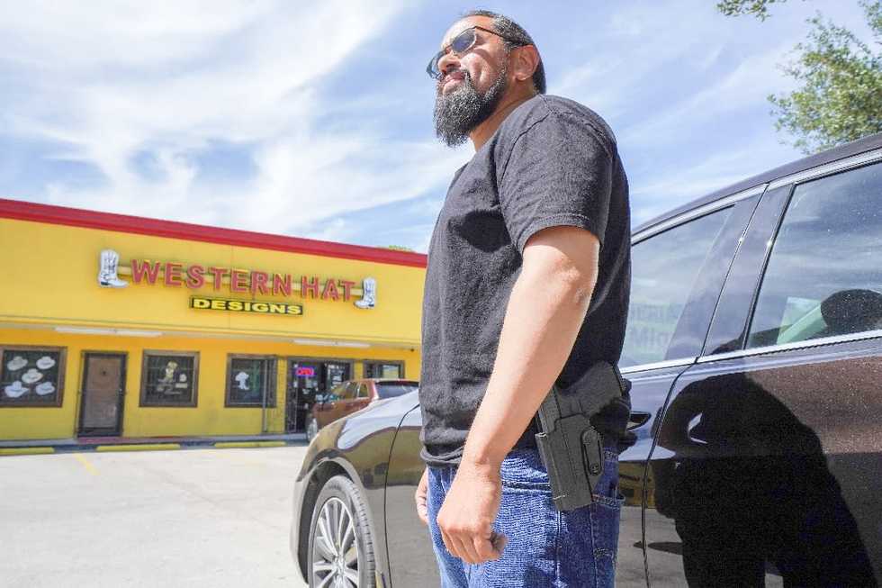 Packing heat and pumping gas, Texas voter defends gun rights