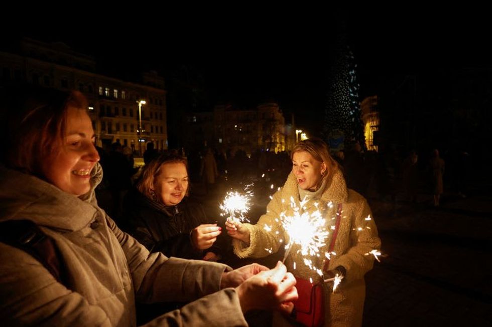Defiant Ukrainians cheer New Year as drones blasted from skies