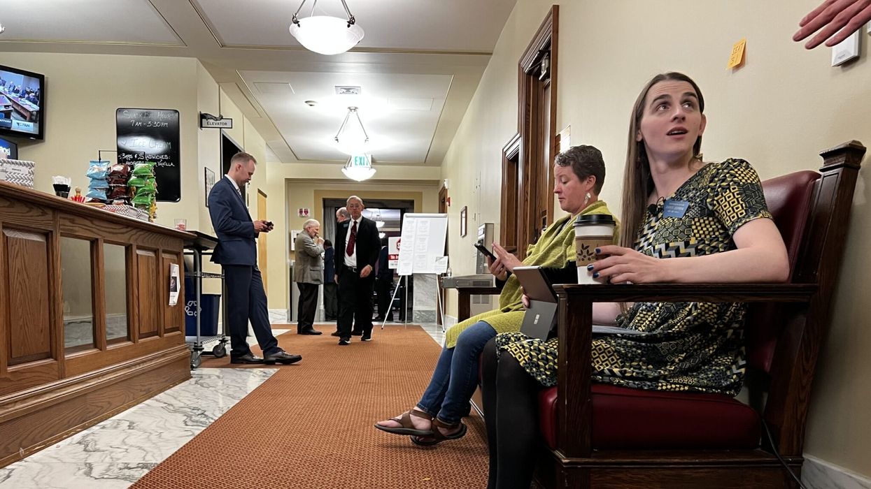 Banned transgender lawmaker working from bench outside Montana House floor