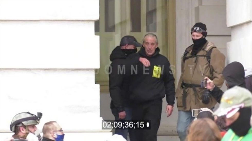 A Pennsylvania man said he rescued a woman from Capitol rioters on Jan. 6. Video shows him punching a cop in the head.