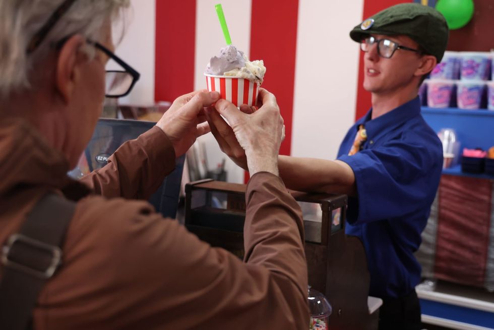 Step right up: Workers in this new gelato shop perform circus acts as they serve up vegan scoops