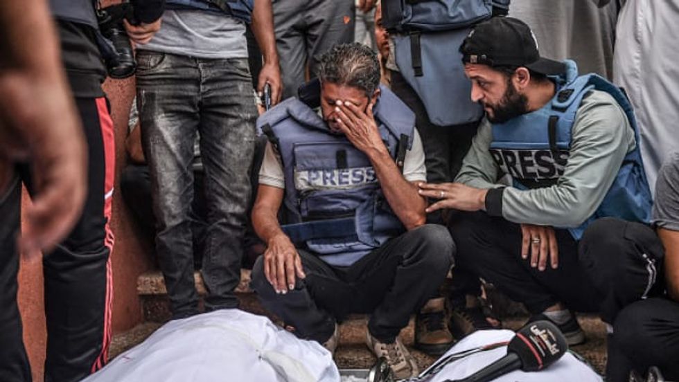 Gaza reporter rips off press vest on-air as colleague dies
