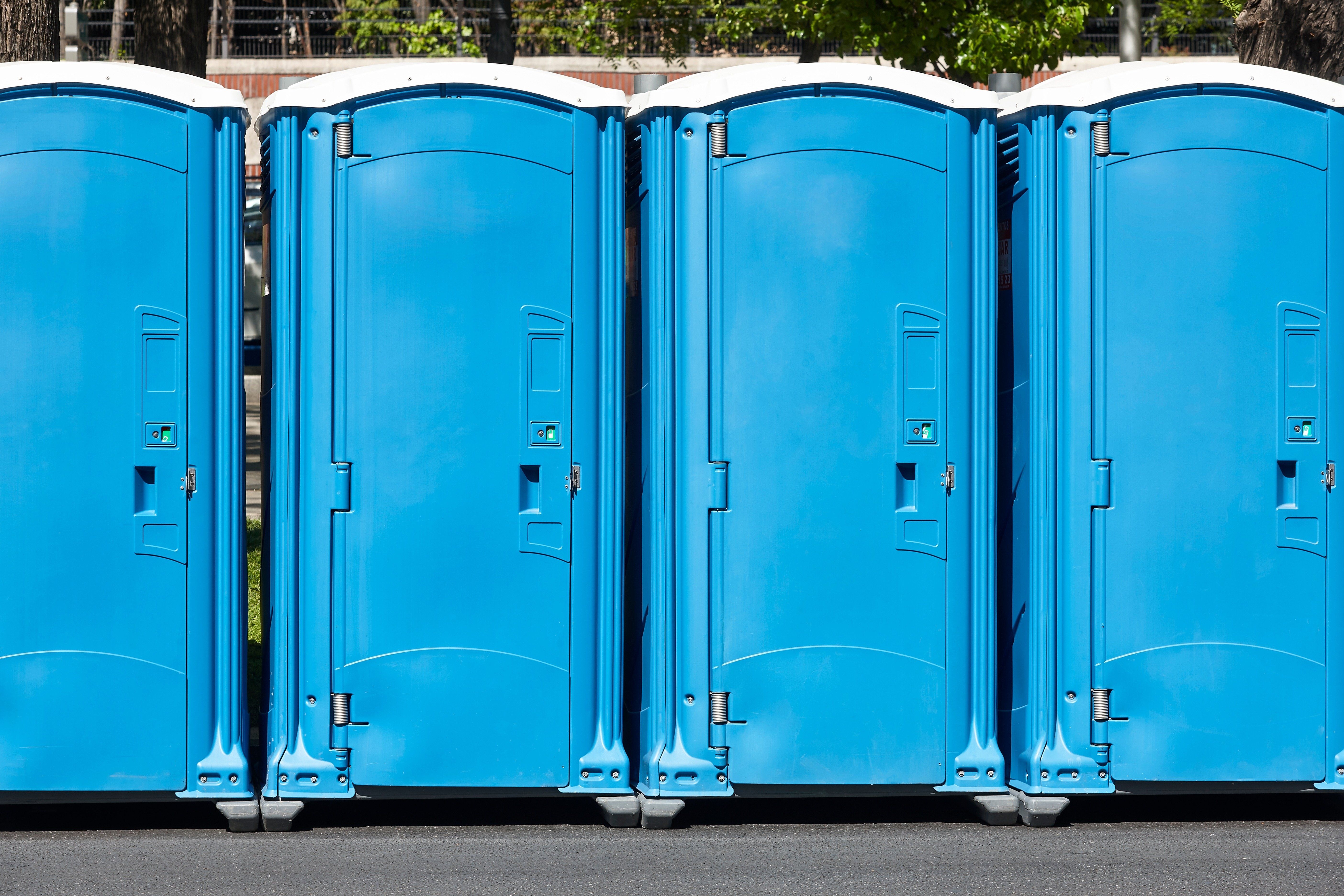 Portable toilets and porta potties in a line