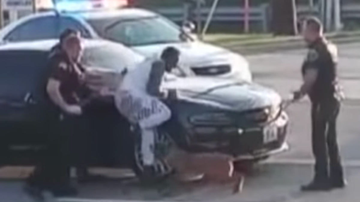 WATCH: White cop allows police dog to repeatedly bite Black suspect pinned against squad car