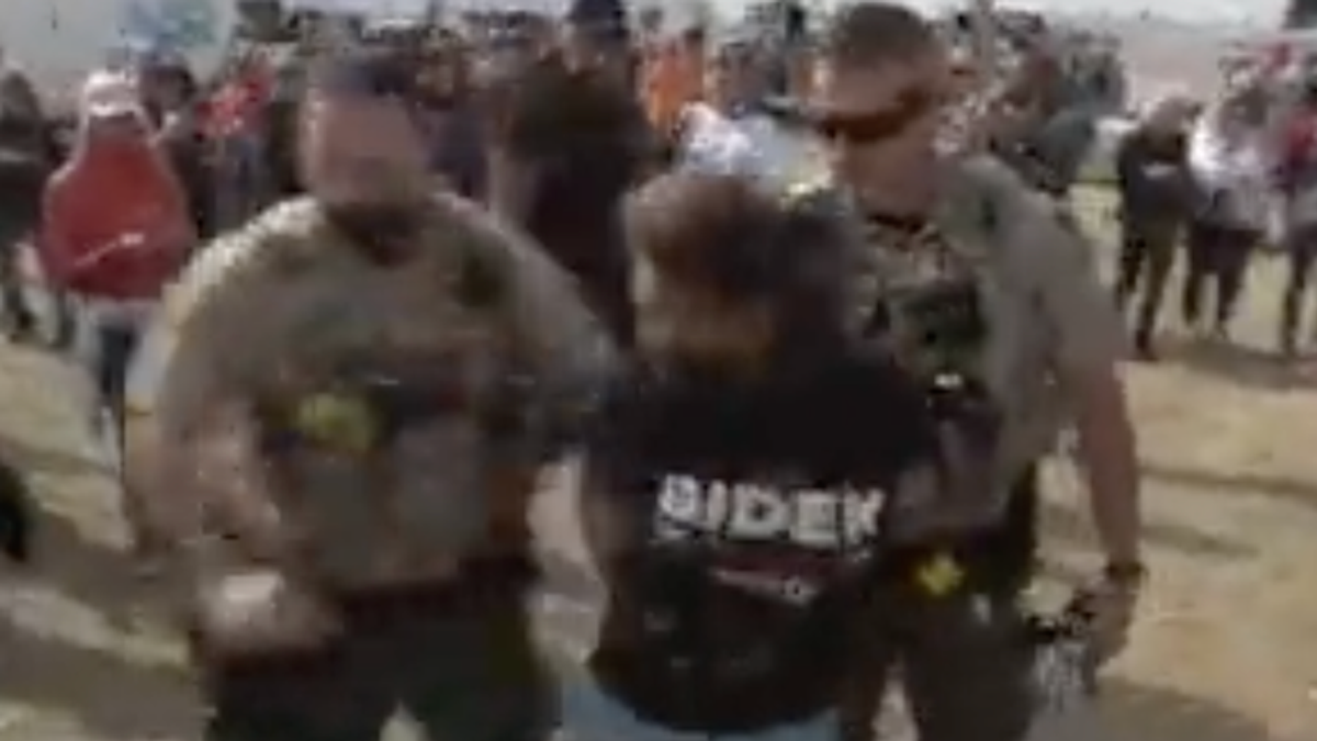 WATCH: Biden supporter arrested at Trump rally for being 'disruptive' and 'heckling' right-wing reporter