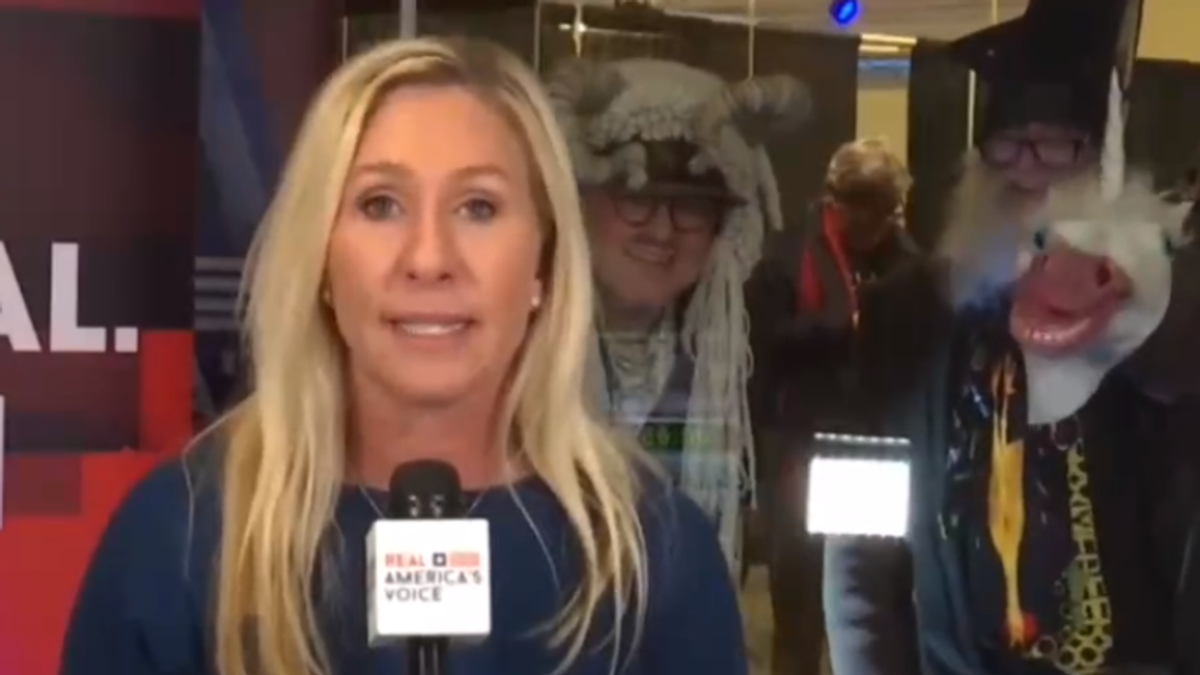 Marjorie Taylor Greene struggles to ignore Vermin Supreme fans photobombing her interview