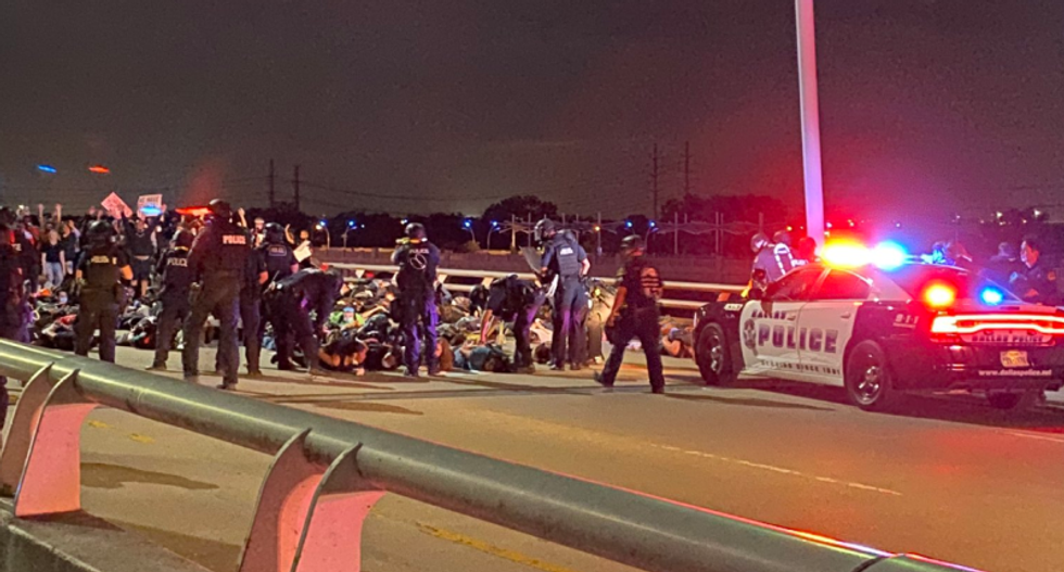 Texas police trap protesters marching across Dallas bridge