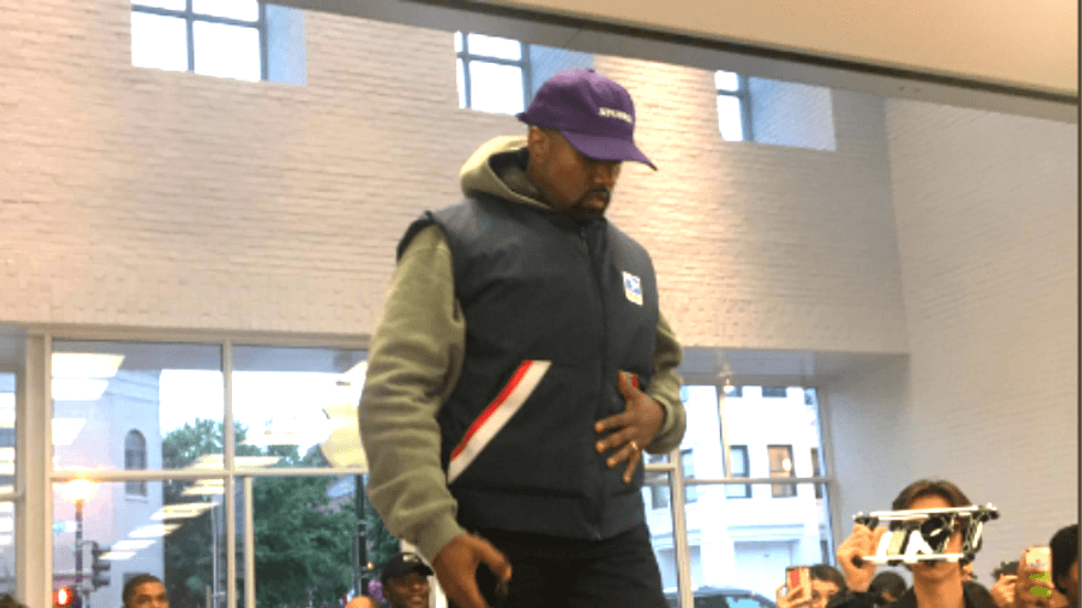 Kanye West goes to Apple Store and climbs on table to give speech after Trump meeting