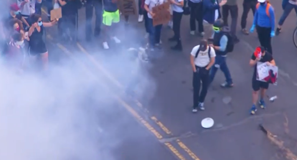 Police and military launch tear gas at peaceful protesters near the White House