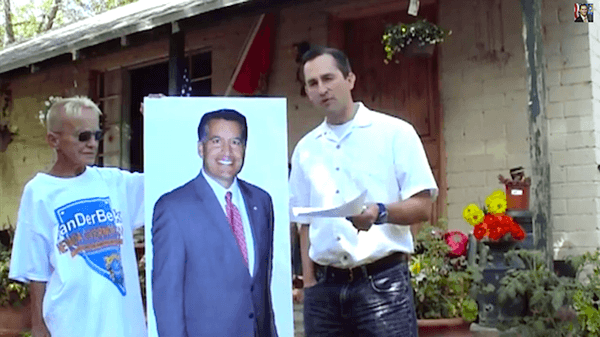 NV gubernatorial candidate debates cardboard cutout at Bundy ranch as roosters heckle him