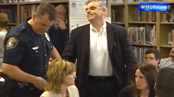 NH dad dares cops to arrest him during school board protest of controversial book assignment