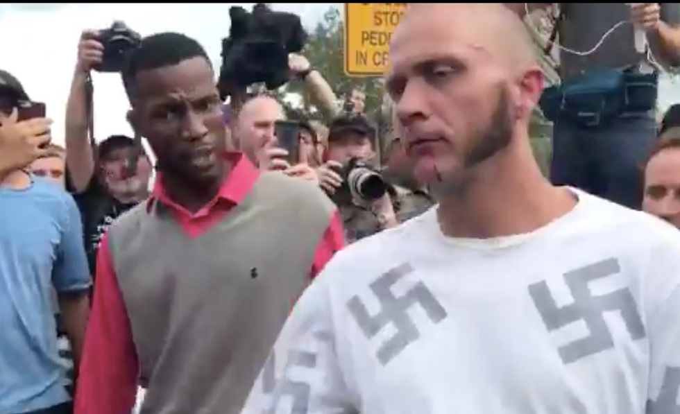 WATCH: Man covered in swastikas gets punched in the face outside Richard Spencer rally