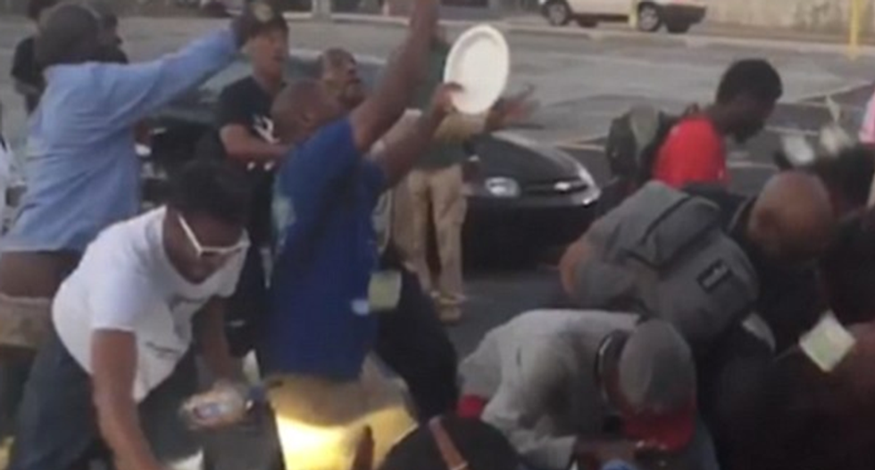 Atlanta rapper mocks homeless people by throwing $30,000 in cash and filming them scramble for it