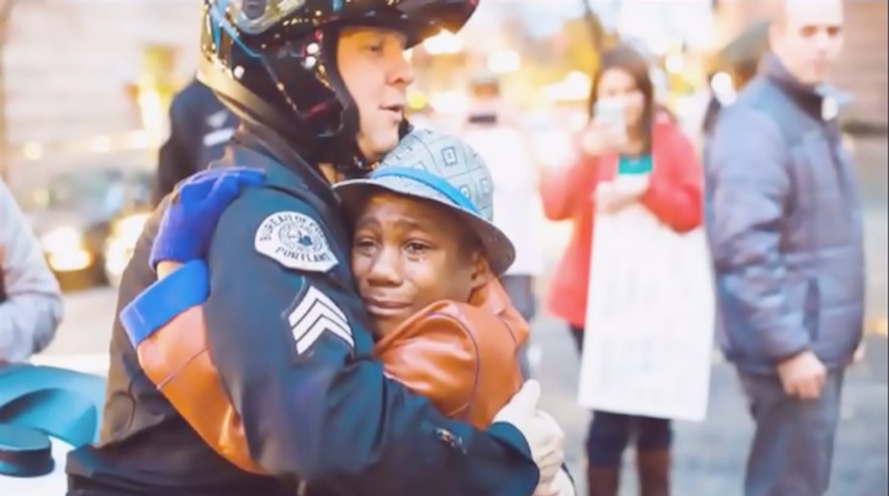 Boy who hugged cop in iconic protest photo may have been killed in fleeing adoptive mother's cliff crash: report