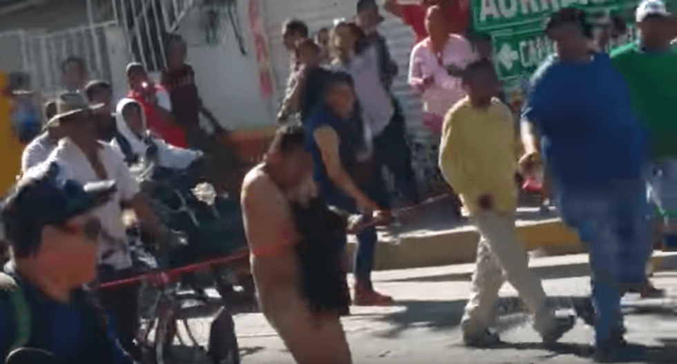 Man forced to march naked through Mexico town after he's caught looting during gas price protests