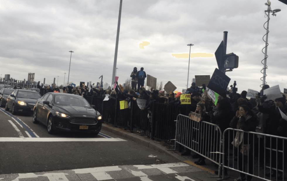 ‘Let them in!’: Protesters gather at JFK Airport to shout down Trump's 'unjust' immigrant detentions