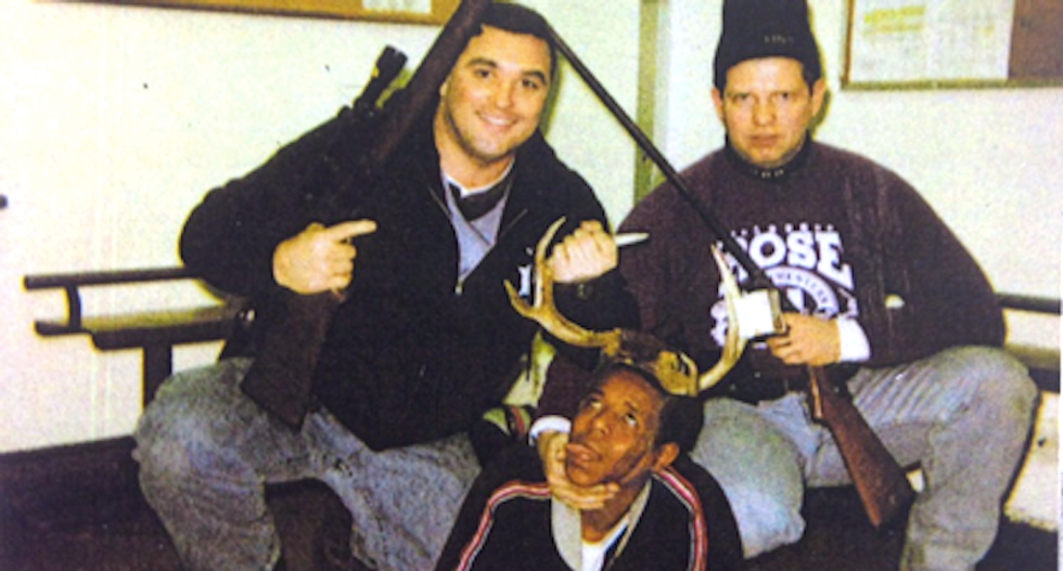 Photo shows rifle-toting Chicago cops posing with a black drug suspect like a hunting trophy