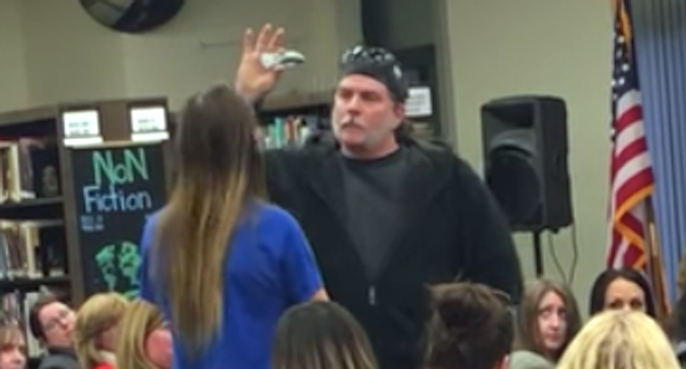 WATCH: Gun-loving dad terrifies teen with knife during school meeting on firearms
