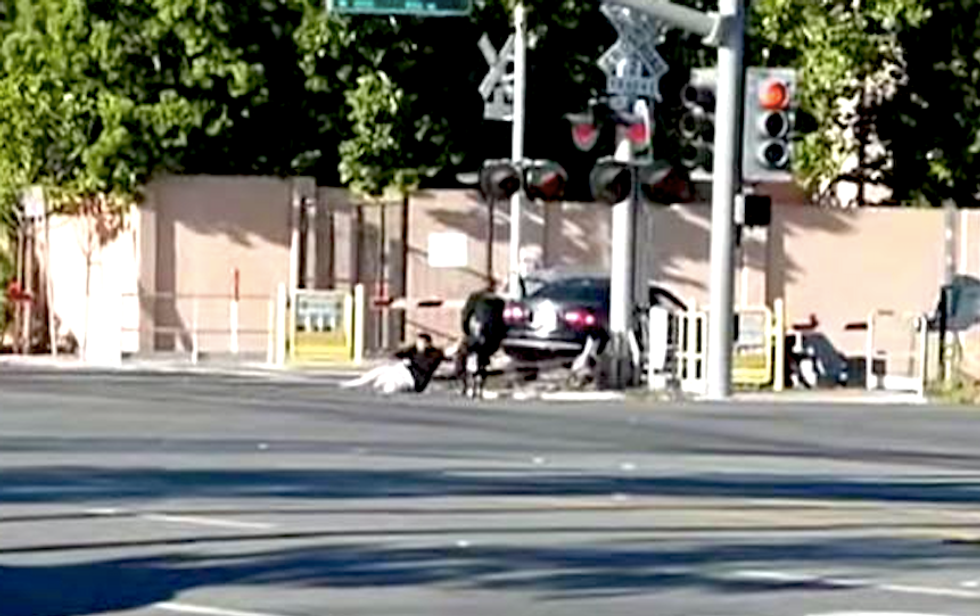 WATCH: Hero cops drag man free of crashed car just before it gets hit by train
