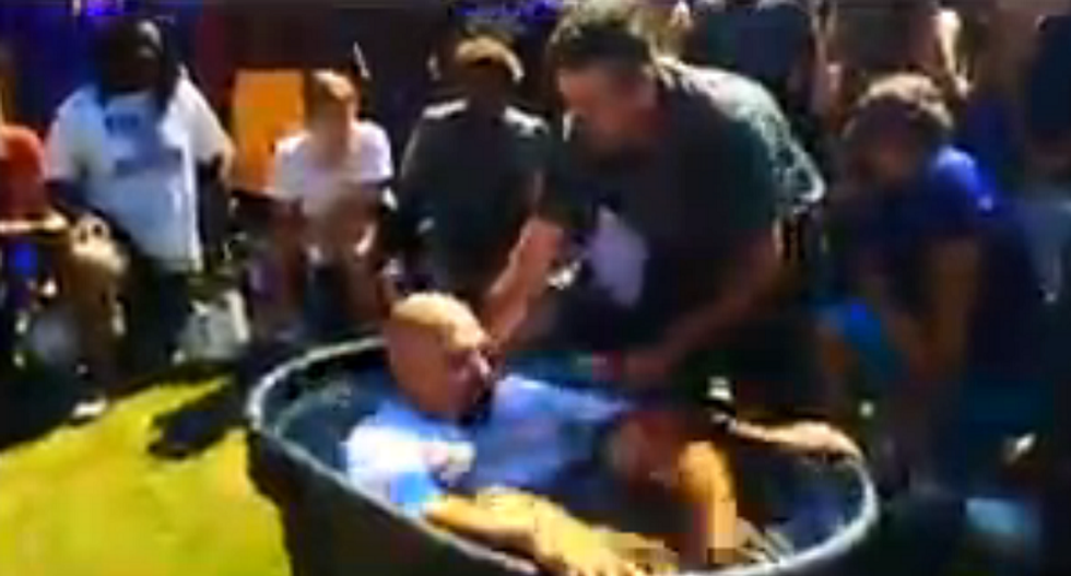 'God is STILL in our schools!': Video shows mass baptism at public high school football practice