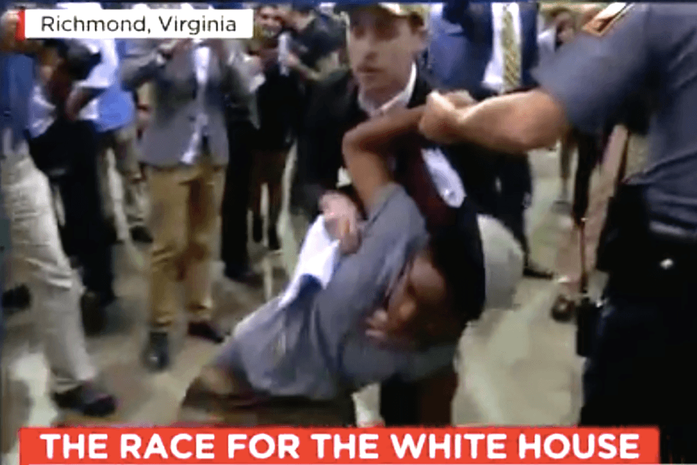 WATCH: Trump rally turns violent when supporter spits in protester's face