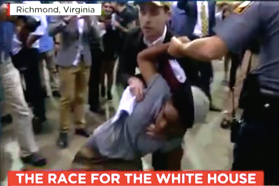 WATCH: Trump rally turns violent when supporter spits in protester's face