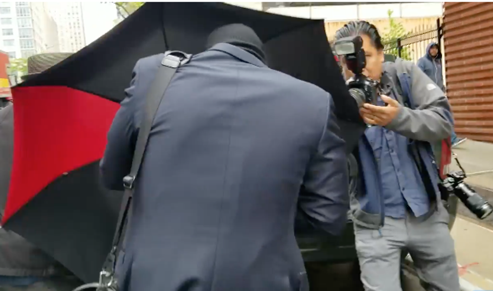 WATCH: Racist NYC lawyer bro tries to hide in his umbrella as he flees reporters outside his home