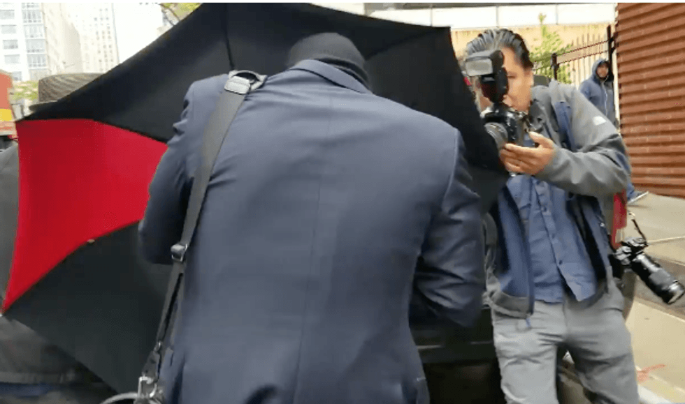 WATCH: Racist NYC lawyer bro tries to hide in his umbrella as he flees reporters outside his home