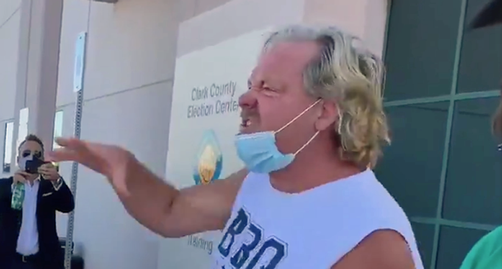 Chin-masked man in ‘BBQ and Beer’ tank-top interrupts presser to shout Biden is ‘stealing’ the election