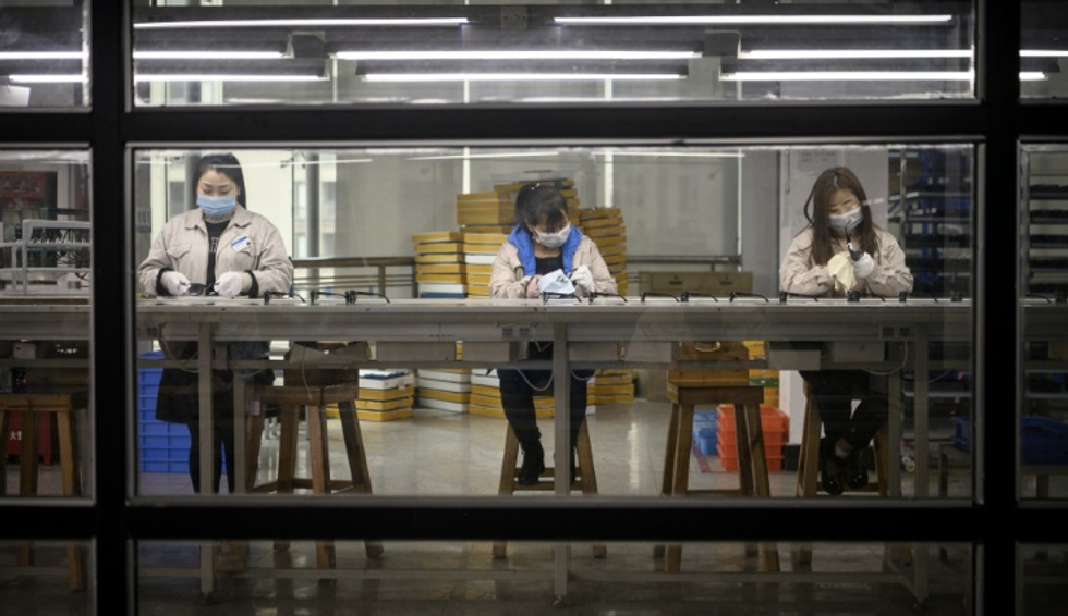 One worker at a time, virus-hit China's factories sputter back online