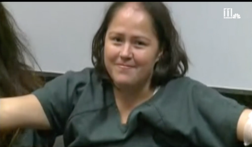 WATCH: Woman accused of stabbing family to death laughs and smiles through bizarre court appearance