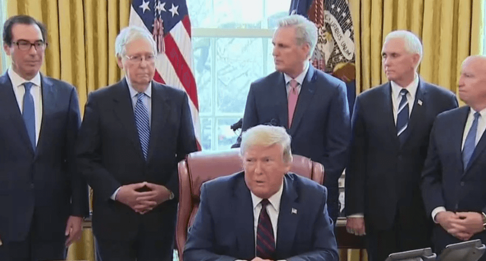 Trump crowds together officials at coronavirus signing ceremony with no social distancing